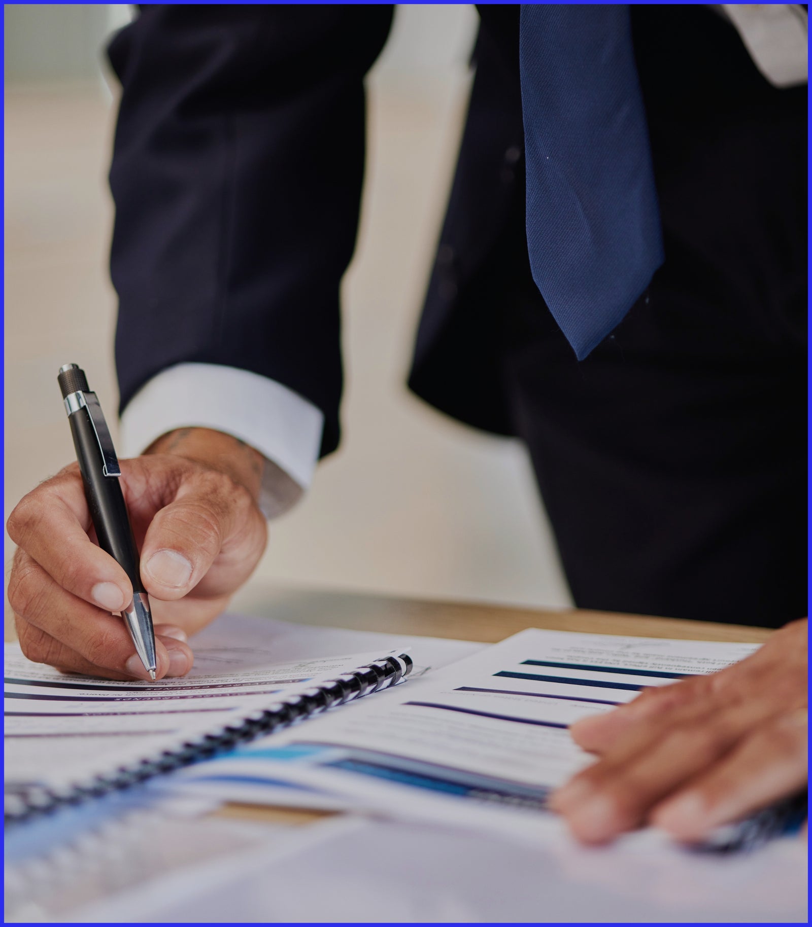 man signing a document